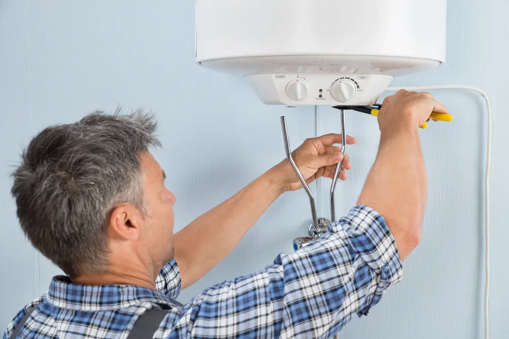Technician installing a new water heater in a San Francisco home