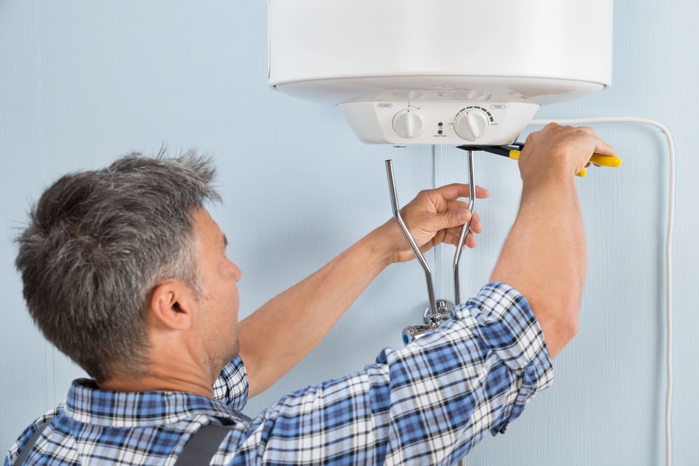Technician installing a new water heater in a San Francisco home