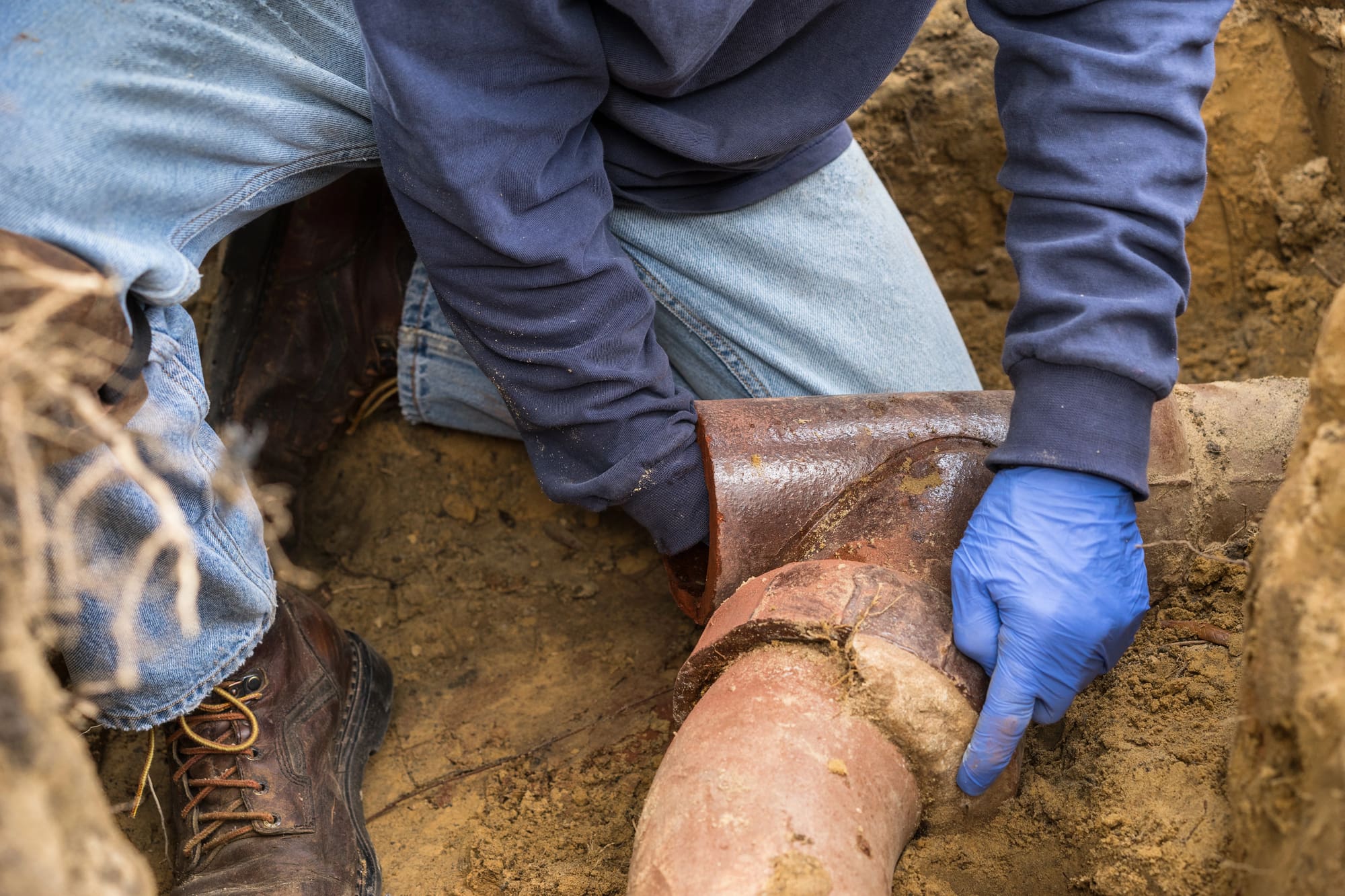Sewer line installation San Francisco technician from O'Grady Plumbing inspecting damaged pipe